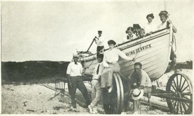 31084. (photo) Visitors Enjoy Life-Saving Service Surfboat on Beach.