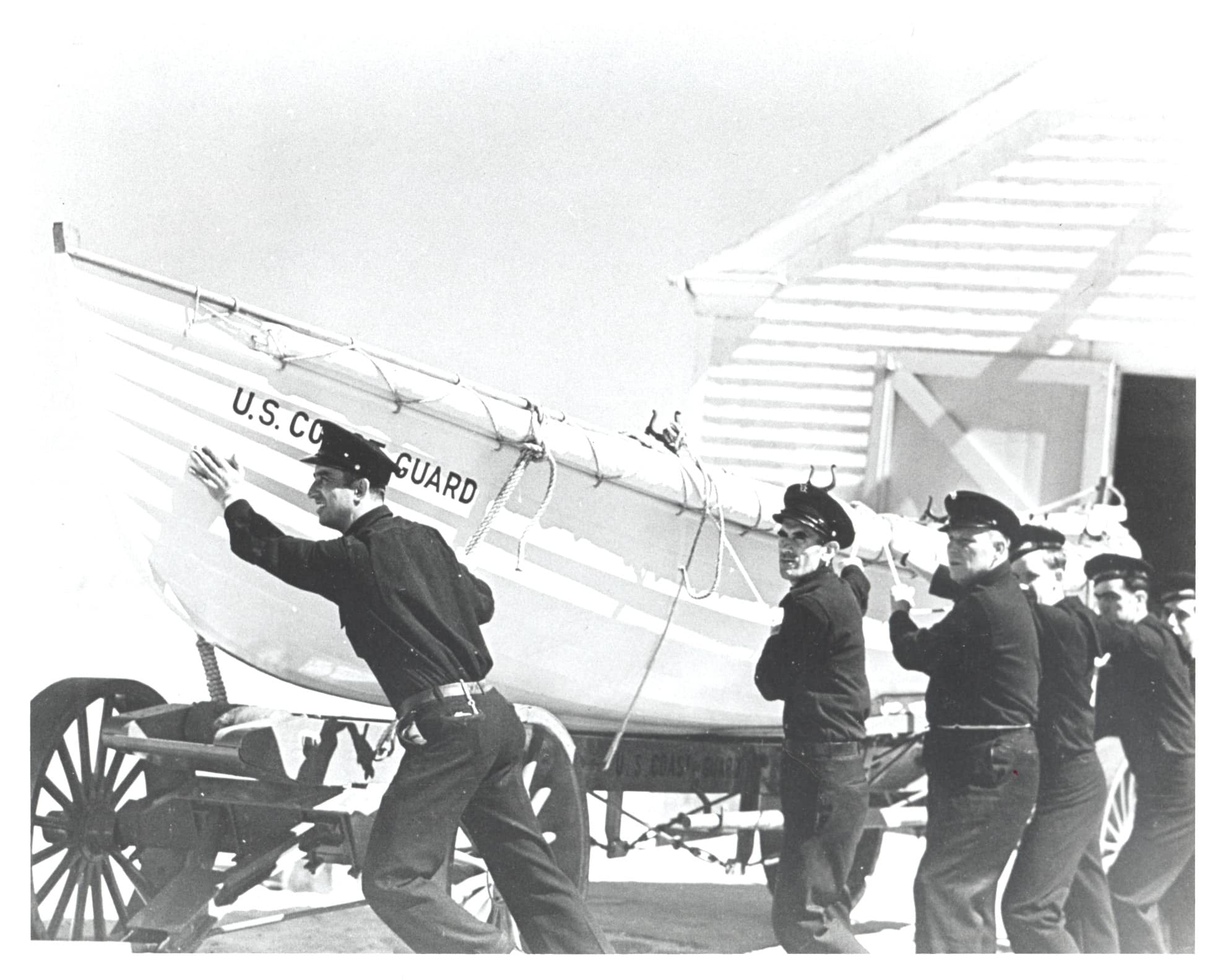 33004. (copy photo) Coast Guardsmen Pull Surfboat and Carriage.