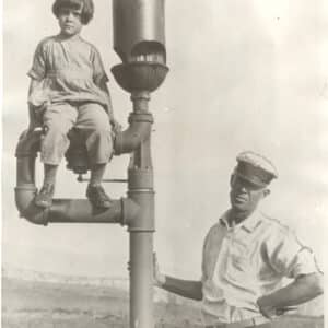33140. (photo) Keeper Bon South with Daughter, Sitting on Fog Whistle, Point Vincente Light Station, California c.1927.